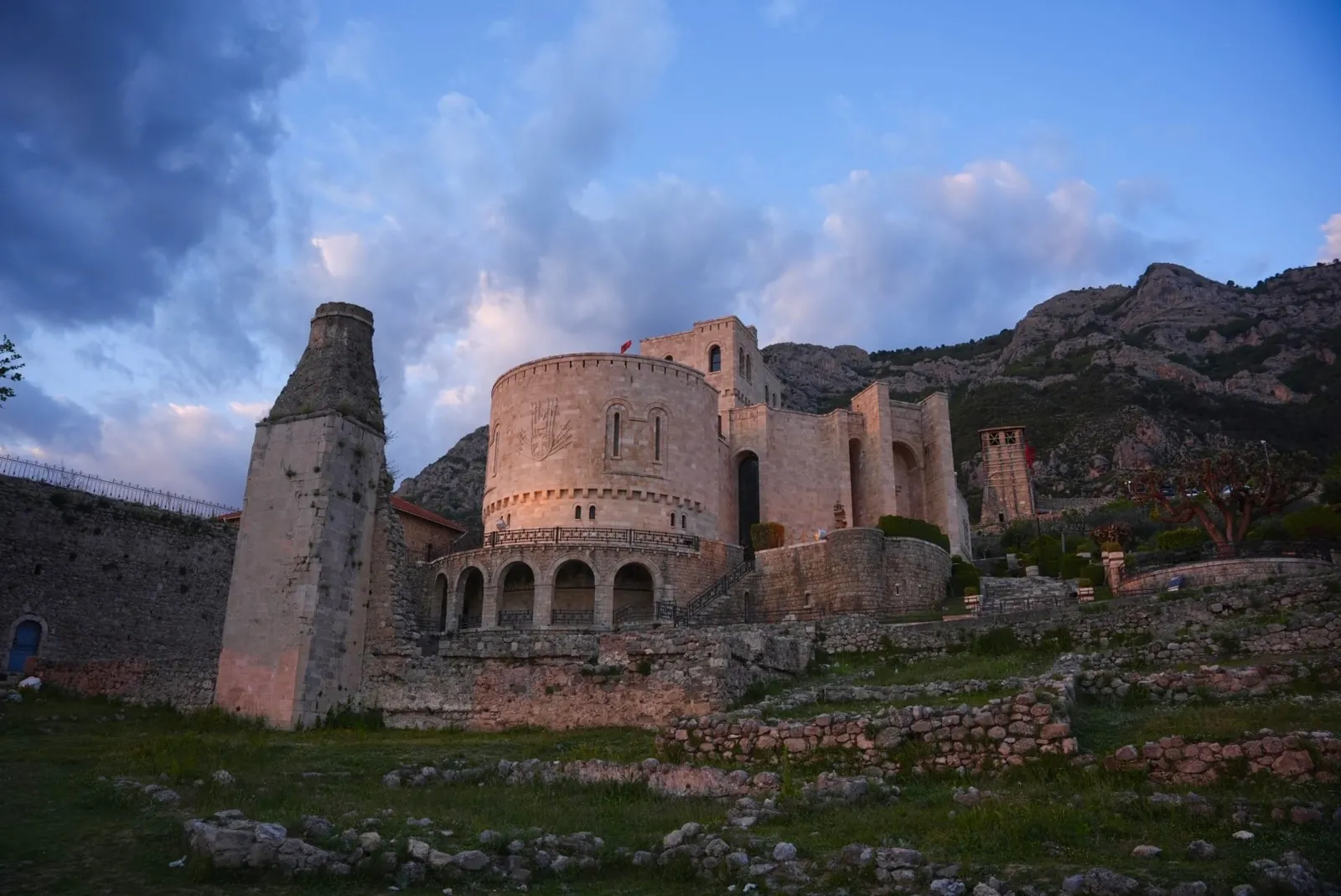 Krujë Castle at dusk under the mountain