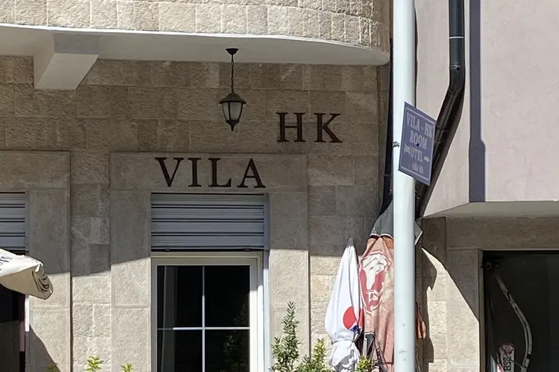 The entrance of Vila HK with the VILA HK letters on the stone wall