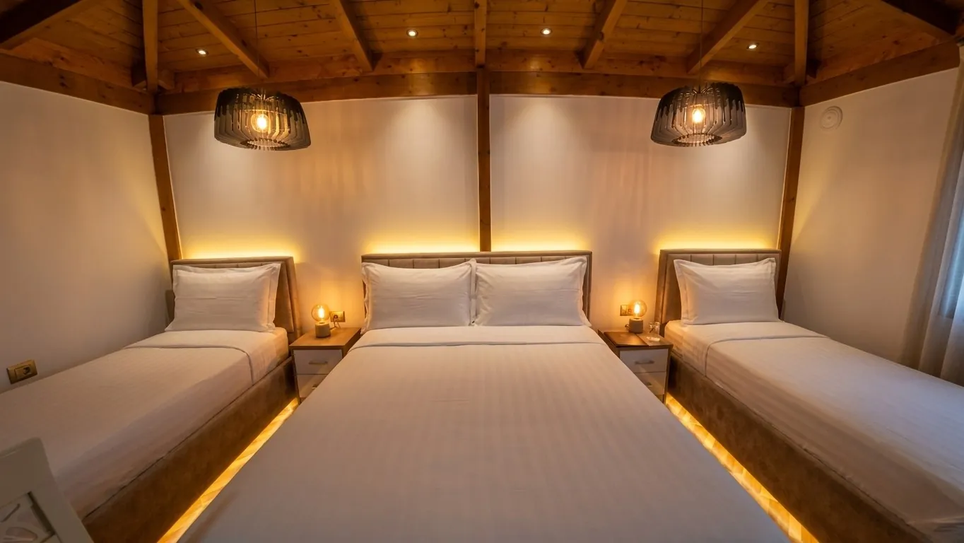 Room under a wooden ceiling with a double bed, two single beds and warm lights